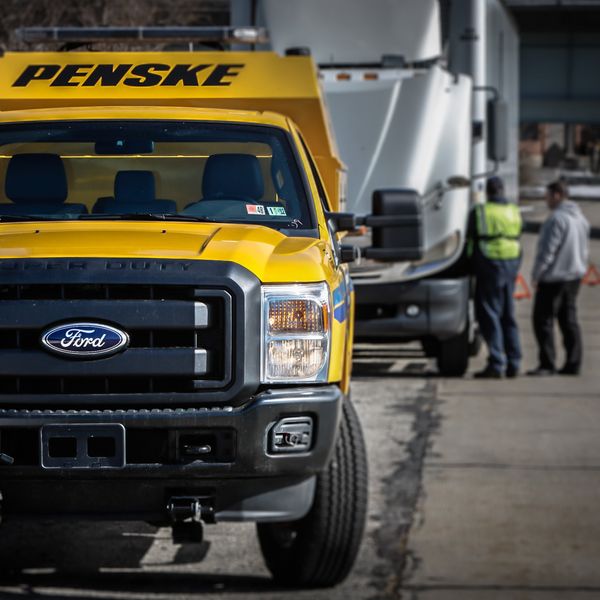 24/7 Roadside Assistance Penske technician fixing a truck.