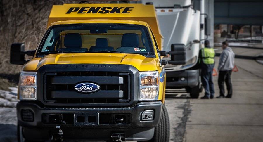 24/7 Roadside Assistance Penske technician fixing a truck.