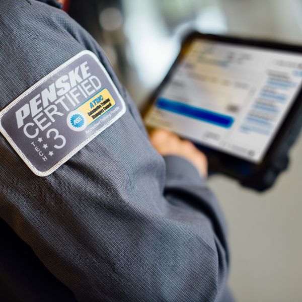 A certified Penske technician reviews maintenance needs on a digital screen.