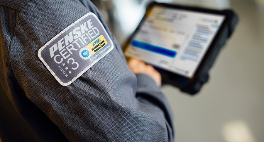 A certified Penske technician reviews maintenance needs on a digital screen.