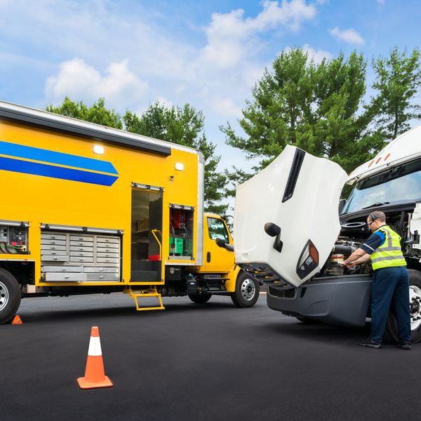 A certified Penske technician works on a truck.