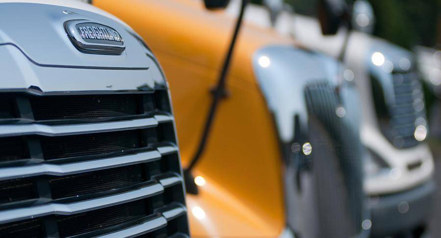 A close up image of semi trucks parked next to eachother.