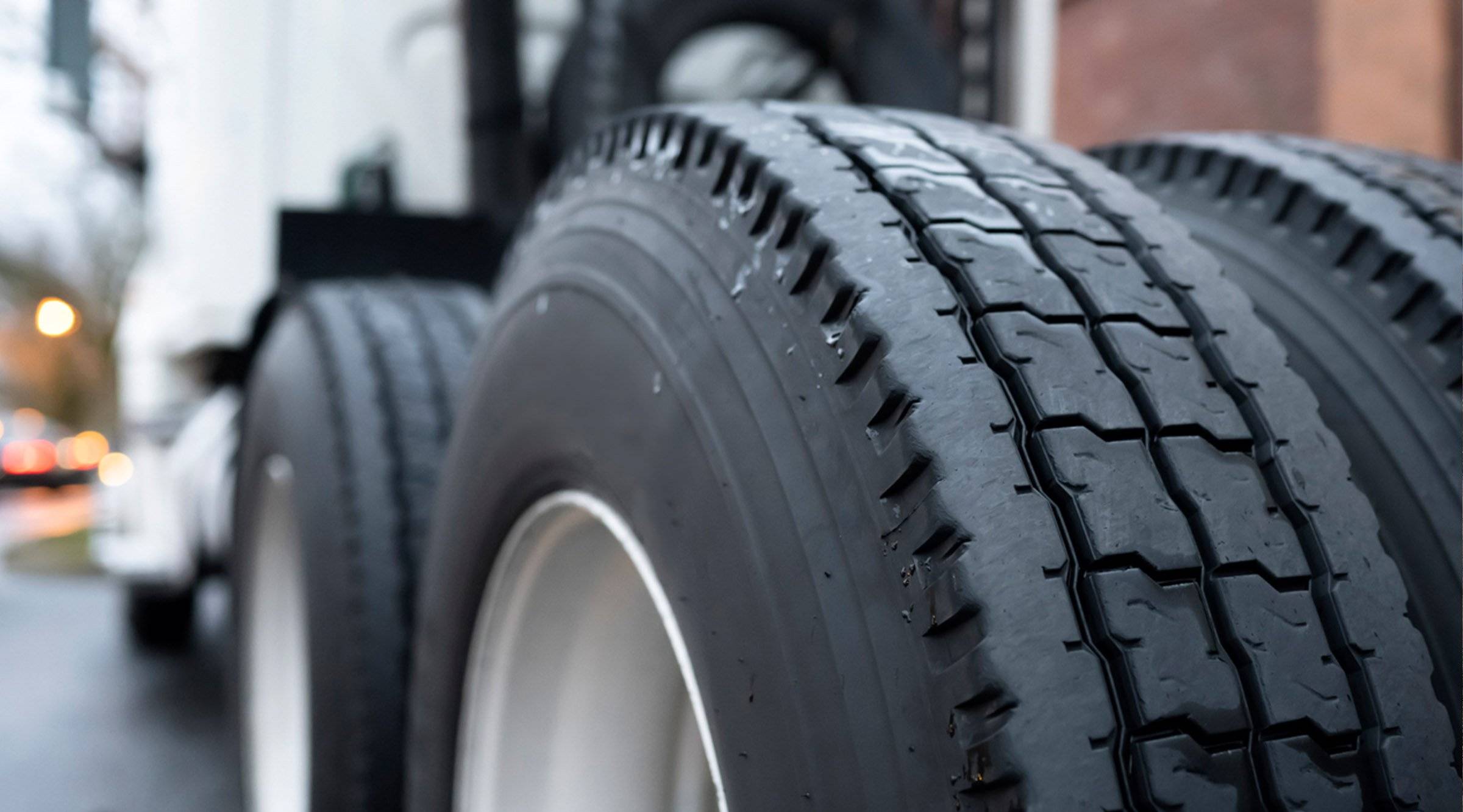 A close-up of tractor truck wheels.