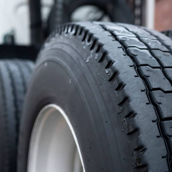 A close-up of tractor truck wheels.