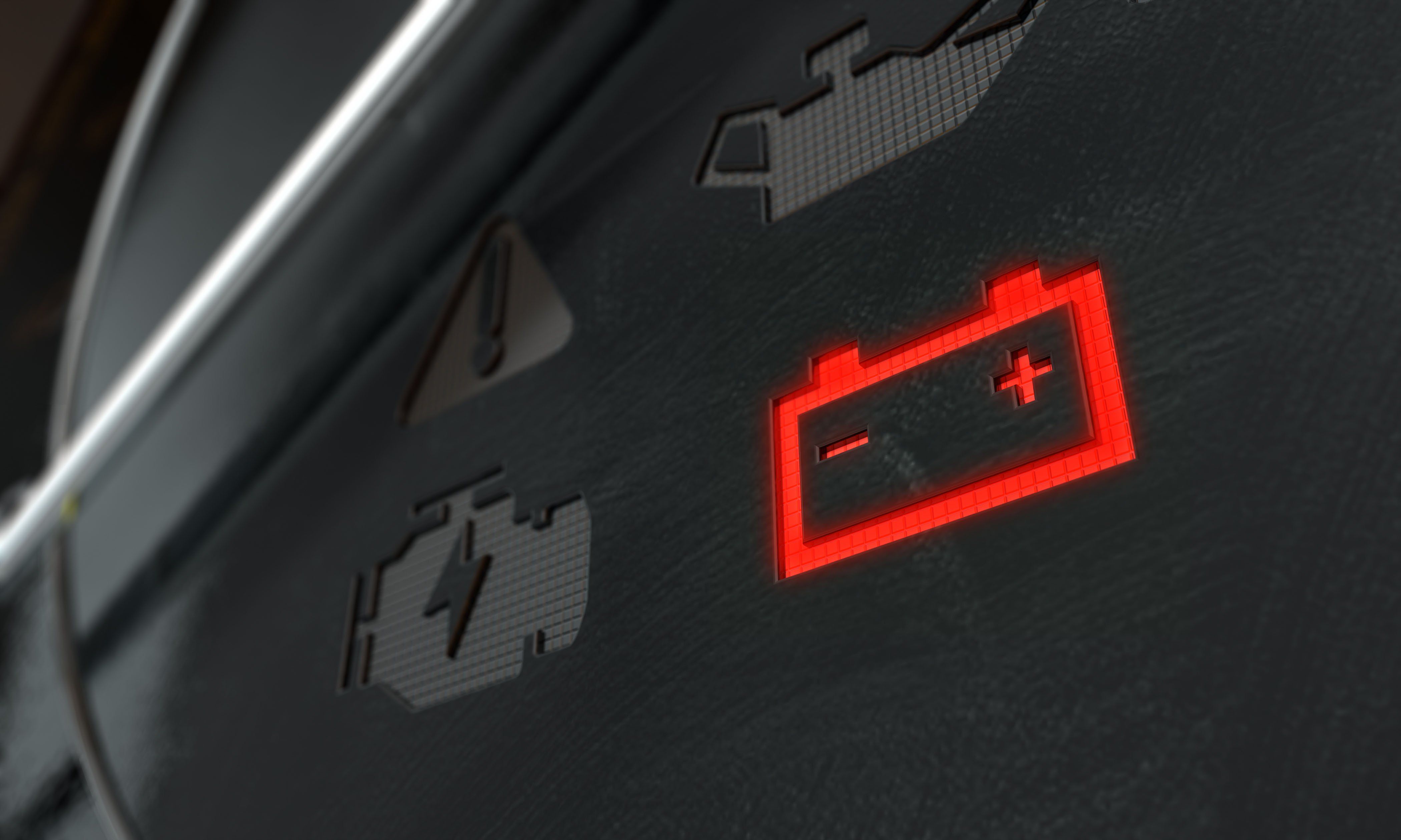 A closeup shot of a lit up red battery icon on the dashboard of a vehicle.