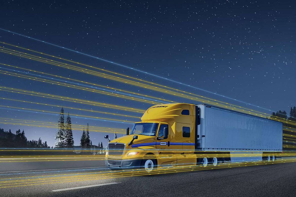 A digitally manipulated photo of a yellow and white Penske semi-truck at night.
