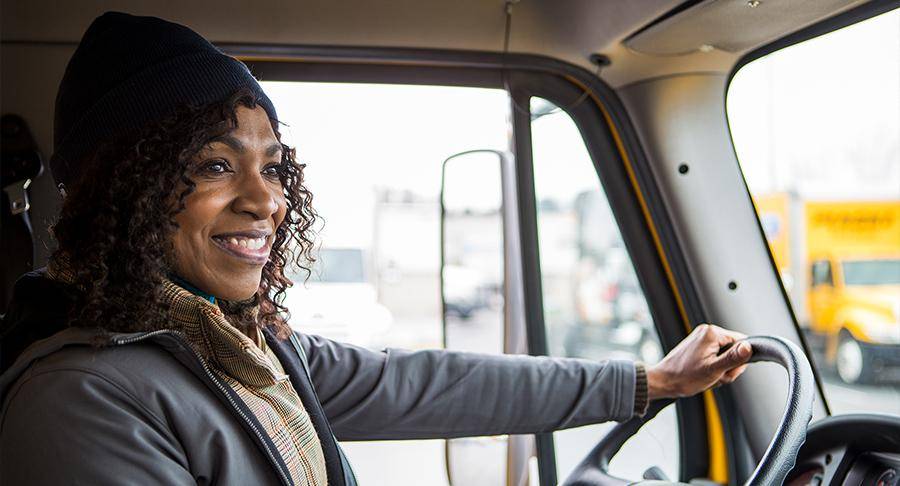 A happy driver works on stress relief for truck drivers.