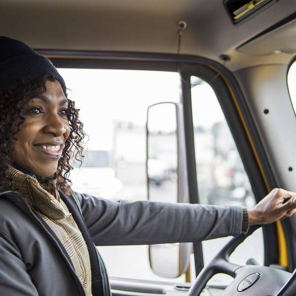 A happy driver works on stress relief for truck drivers.