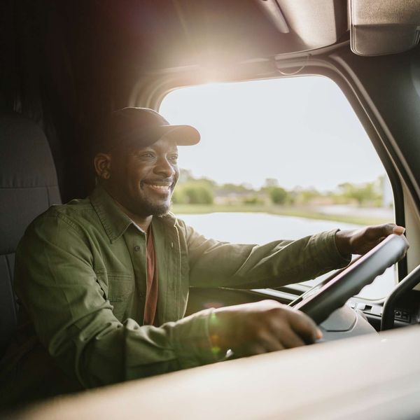 A man driving a semi-truck.