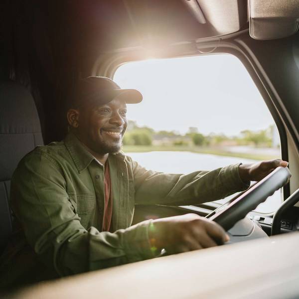 A man driving a semi-truck.