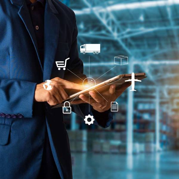 A man in a dark blue suit in a warehouse looks at a tablet device with a supply chain graphic overlayed on top.