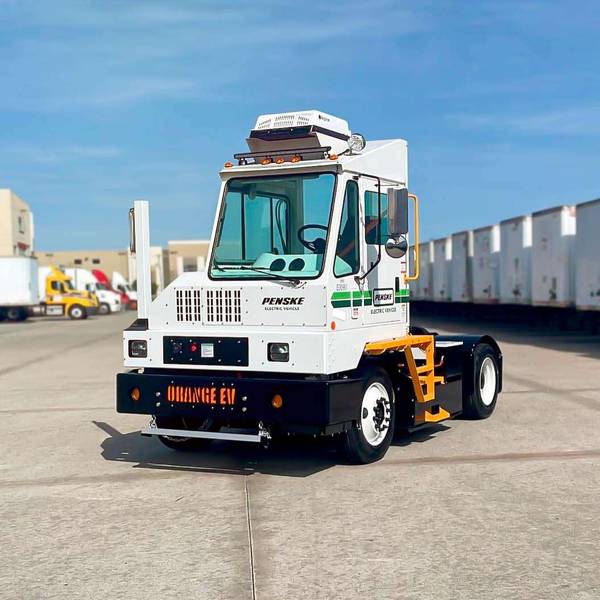A Penske electric yard truck in a parking lot.