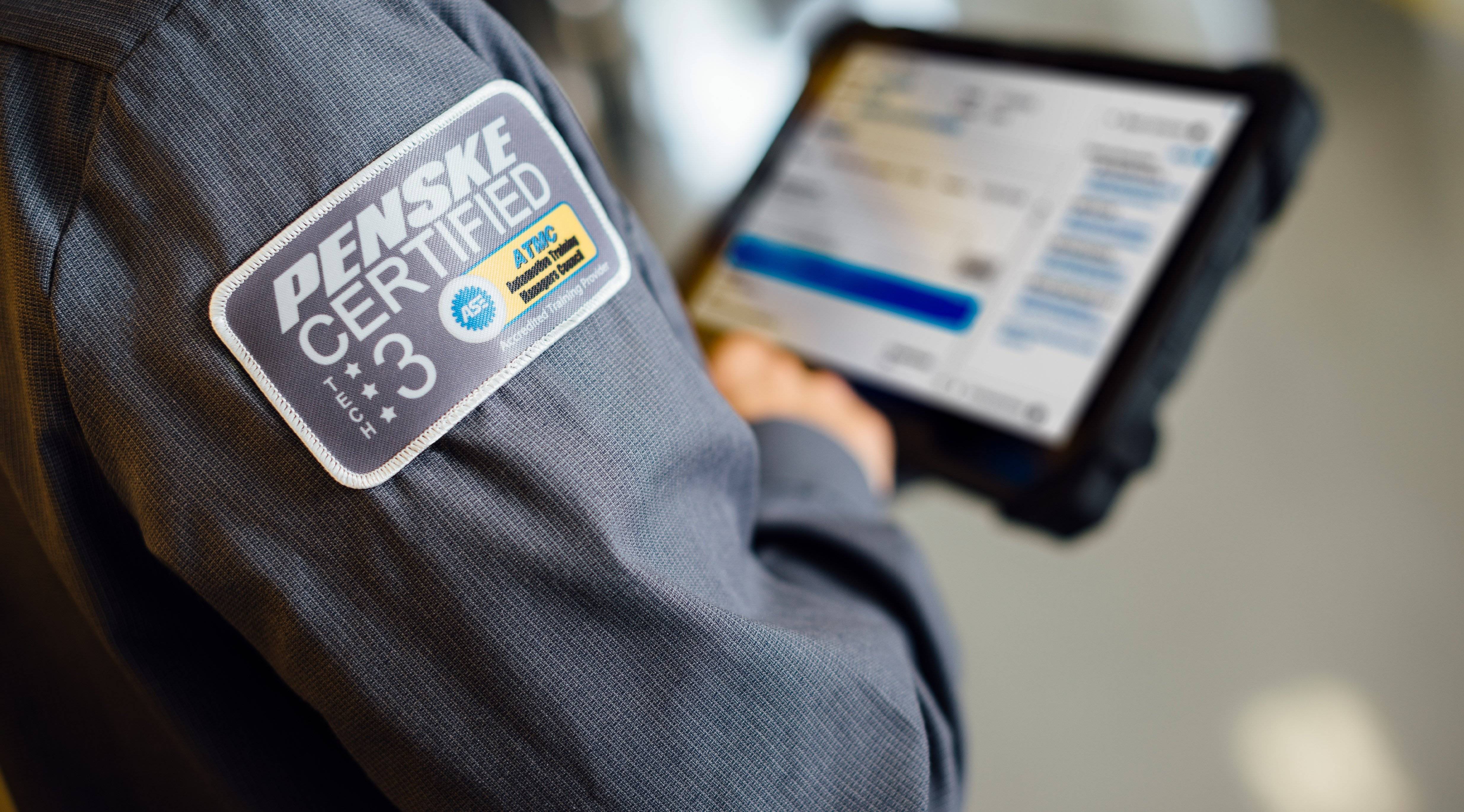 A Penske Technician looks at an ipad