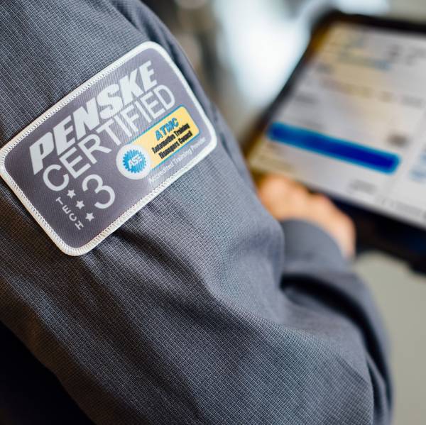 A Penske Technician looks at an ipad