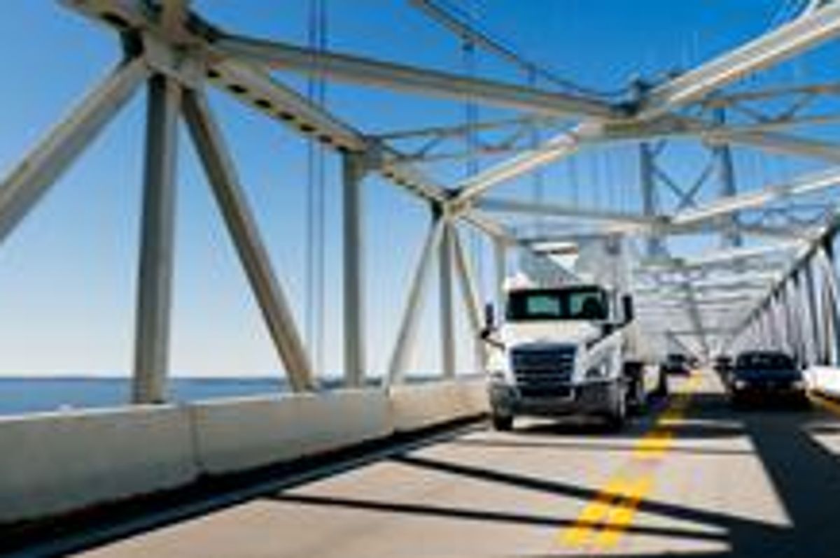 A Penske truck and car practicing safe summer driving.