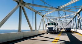 A Penske truck and car practicing safe summer driving.