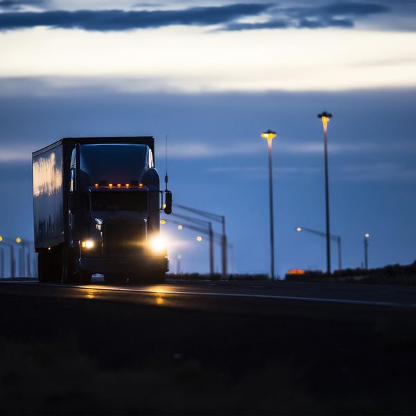 A semi-truck driving at night