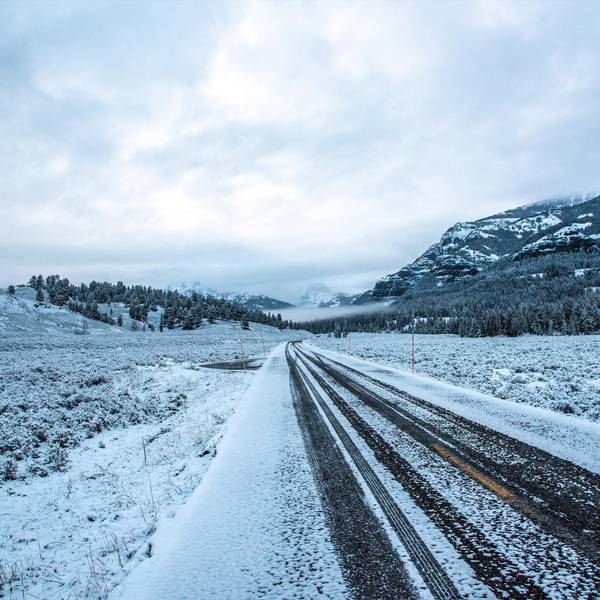 A snow-covered empty road.