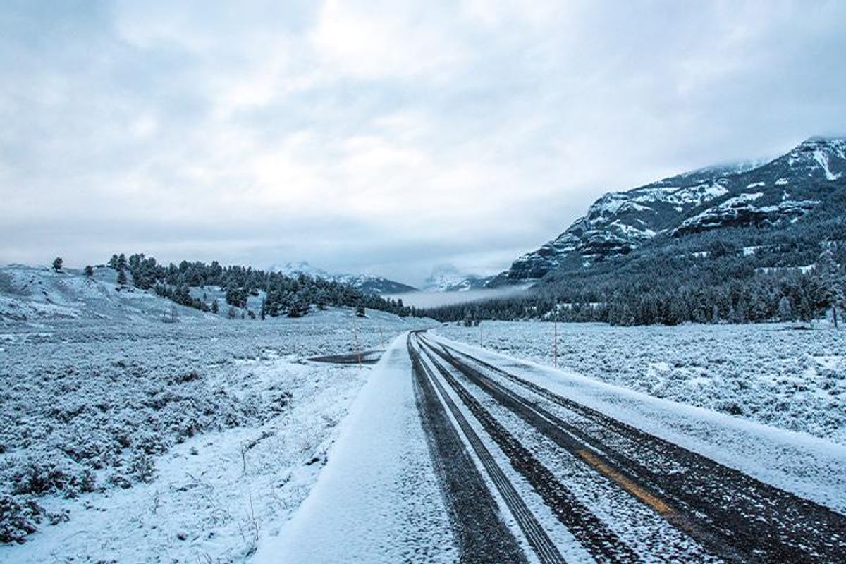 A snow-covered empty road