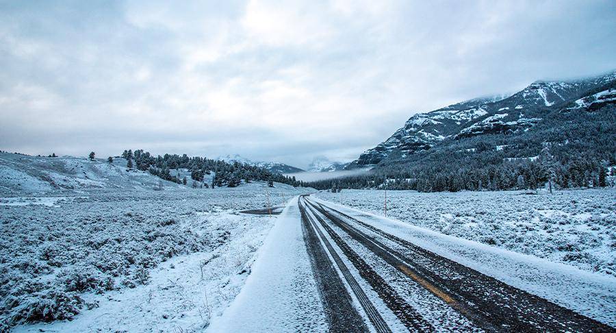 A snow-covered empty road