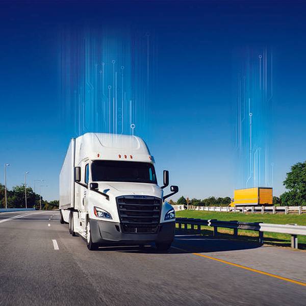 A white Penske semi-truck and yellow Penske box truck drive in opposite directions of a freeway.