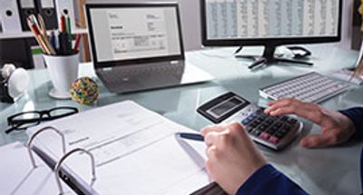 Businessperson Calculating Invoice