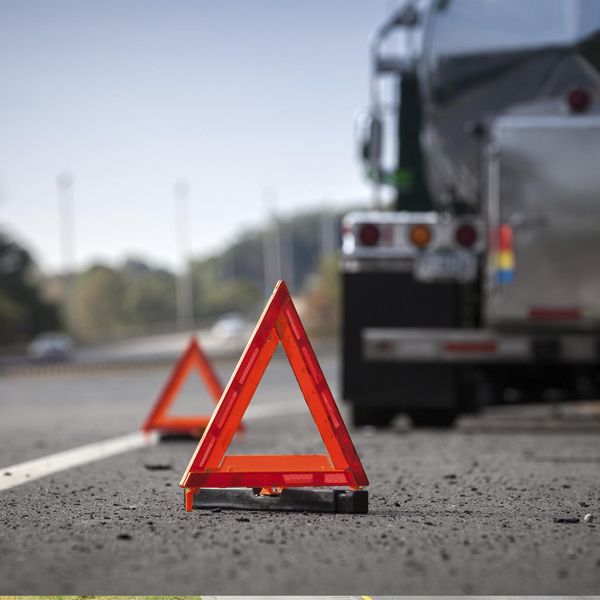 Caution triangles on the road warning of a stopped truck.