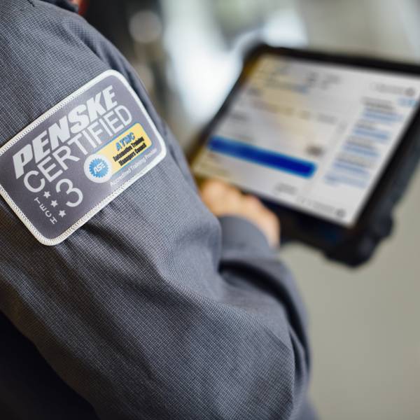 Close-up of a Penske maintenence technician looking at an iPad.