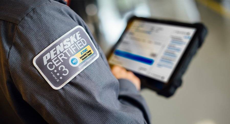 Close-up of a Penske maintenence technician looking at an iPad.