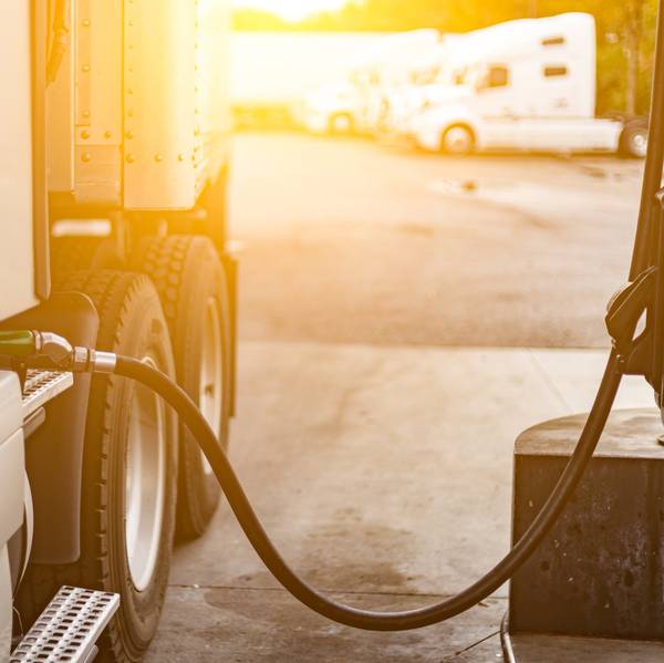 Close up of fuel being pumped into the fuel tank of a truck.