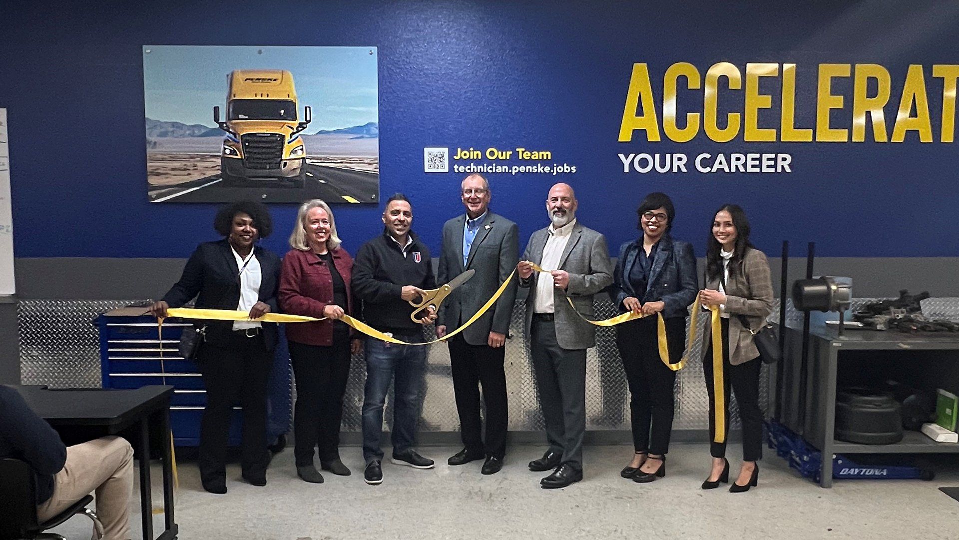 Group of people at a ribbon-cutting event.