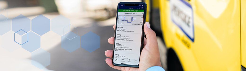Hand holding smartphone with Penske Driver App displayed