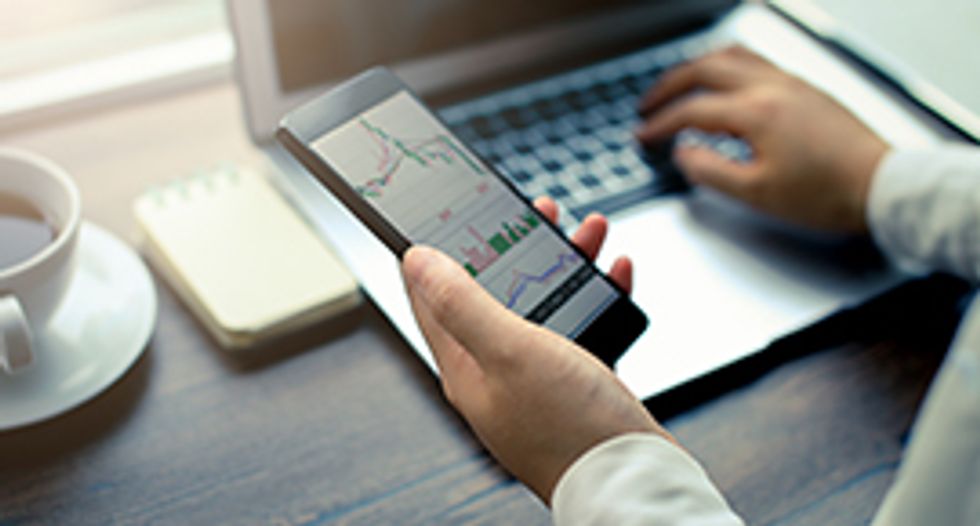 Hand Holding Smartphone with Stock Graph