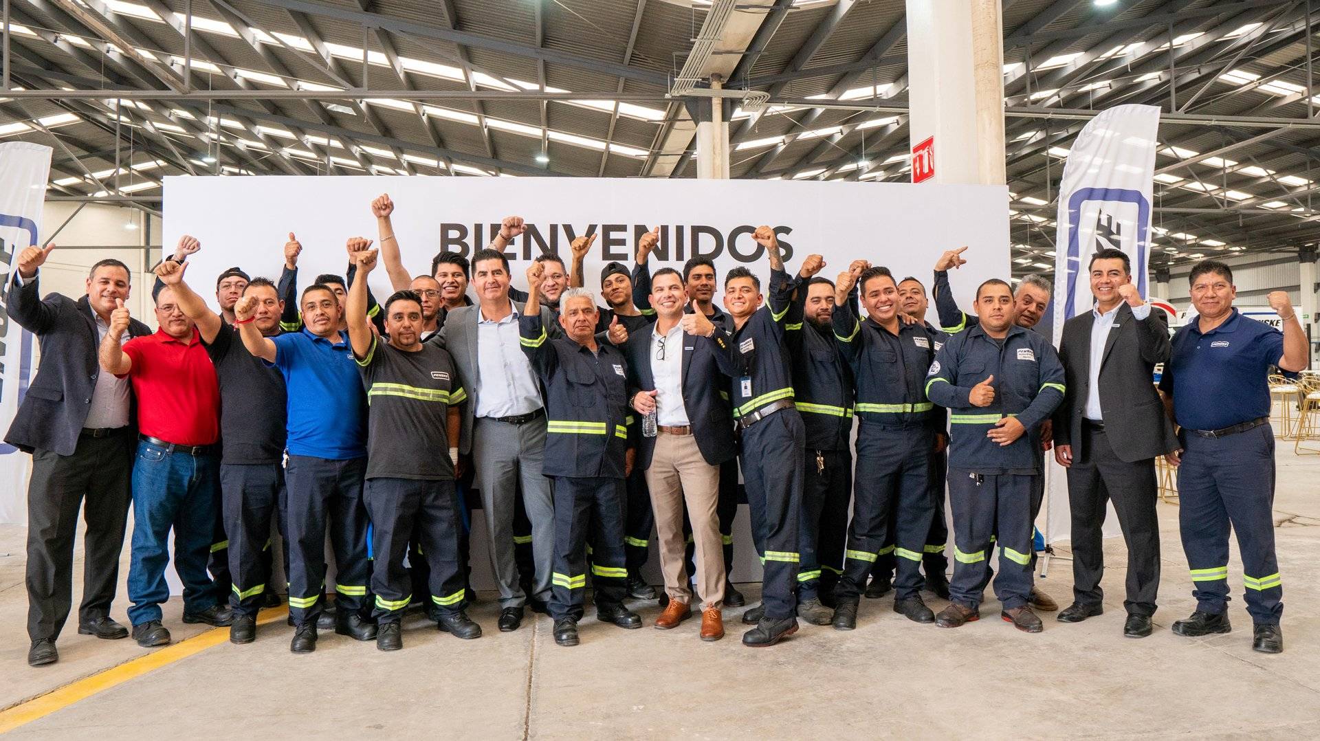 Large group of people celebrating the opening of a new facility.