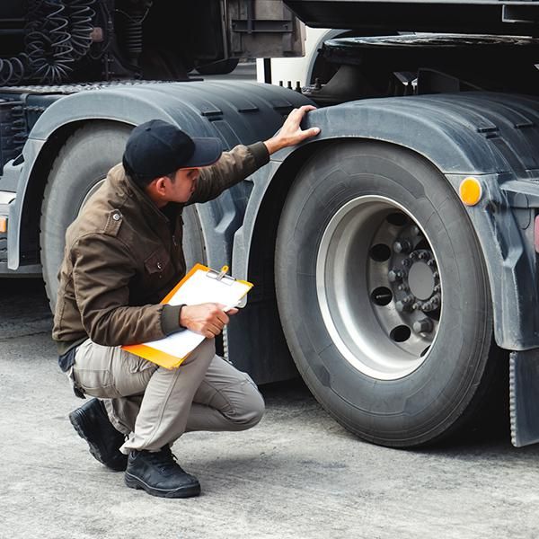 Man checking tires on truck