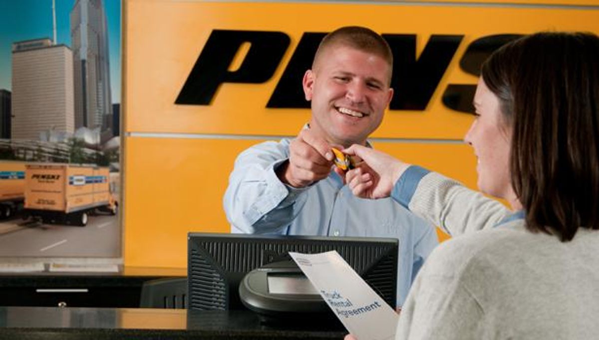 Penske associate behind the rental counter assisting a customer