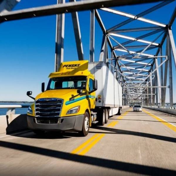 Penske tractor driving over bridge