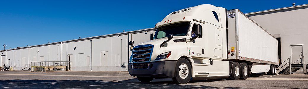 Penske tractor trailer at warehouse loading dock