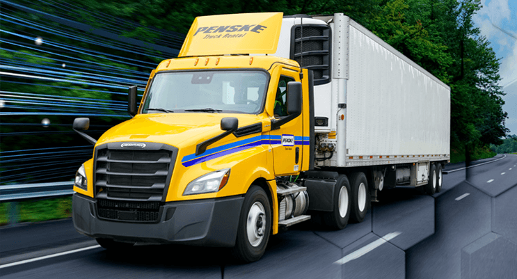 Penske tractor trailer driving down a highway
