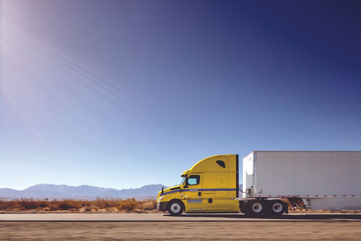 Penske tractor trailer driving on the road