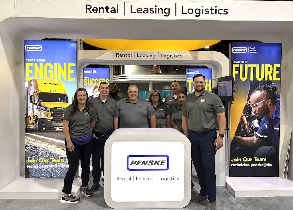 People at a convention standing near a podium