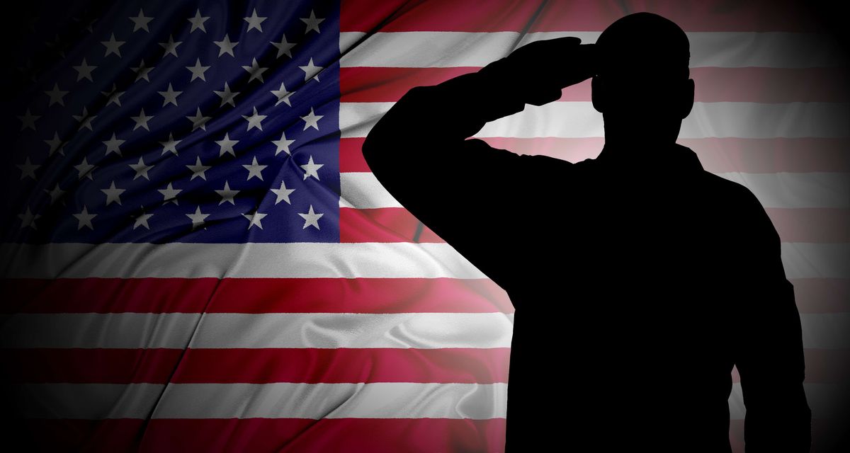 Soldier's saluting silhouette against an American flag