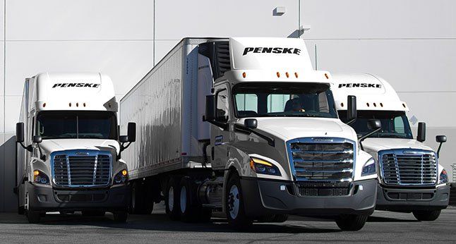Three Penske trucks