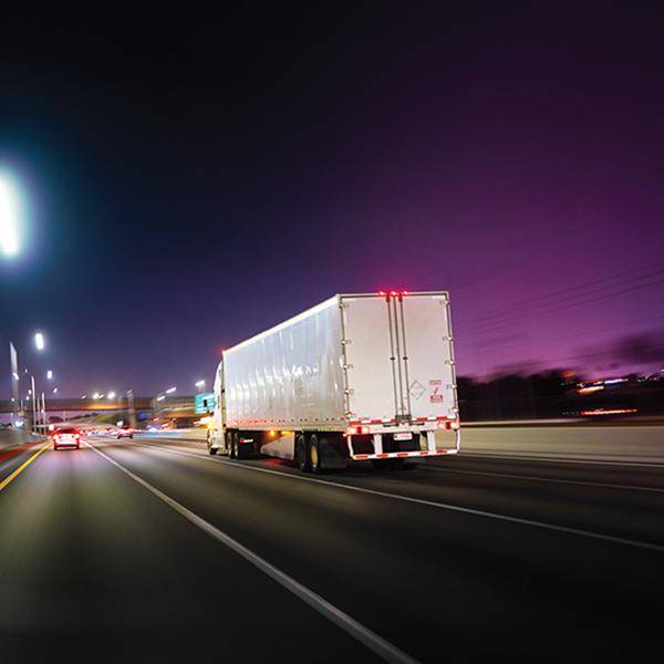 Truck driving at night.