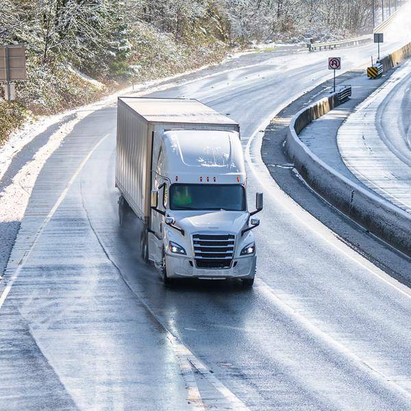 Truck driving in winter landscape