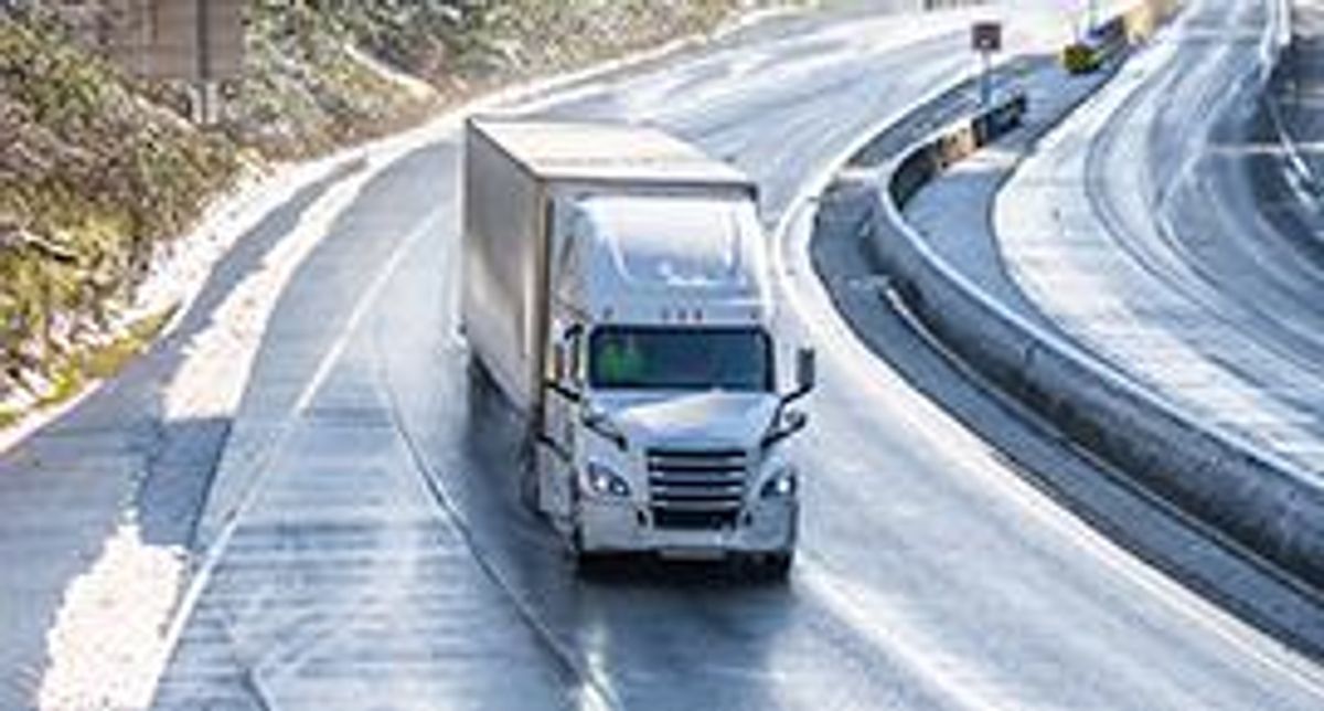 Truck driving in winter landscape