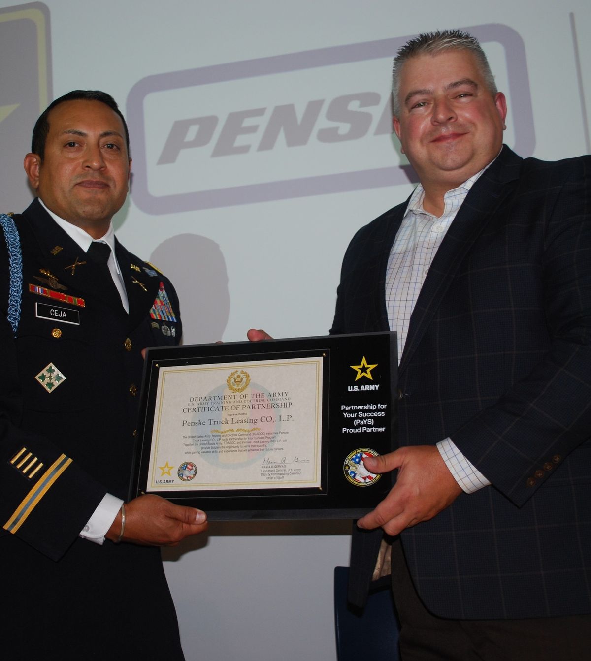 Two men holding a plaque.