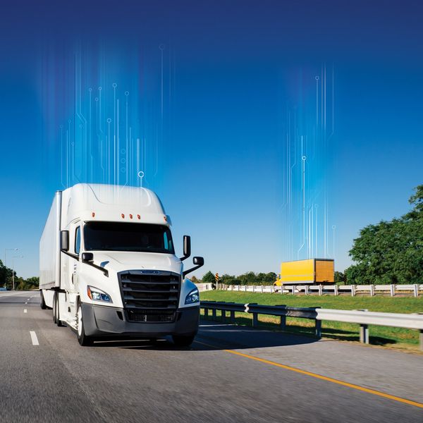 Two Penske trucks drive on opposite sides of a highway. Both have digitized lines going up from the roof toward the blue sky.