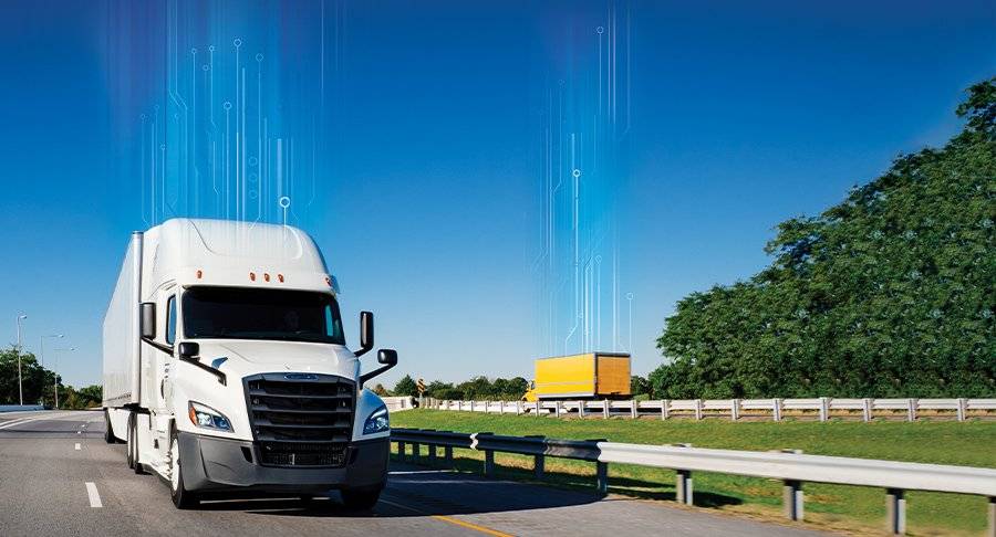 Two Penske trucks drive on opposite sides of a highway. Both have digitized lines going up from the roof toward the blue sky.