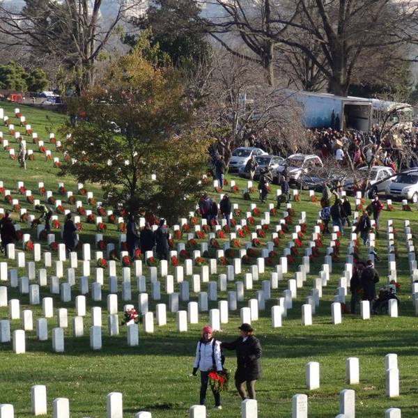 Two people lay wreaths at Arlington National Cemetery